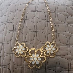 Gold floral necklace with white iridescent accents